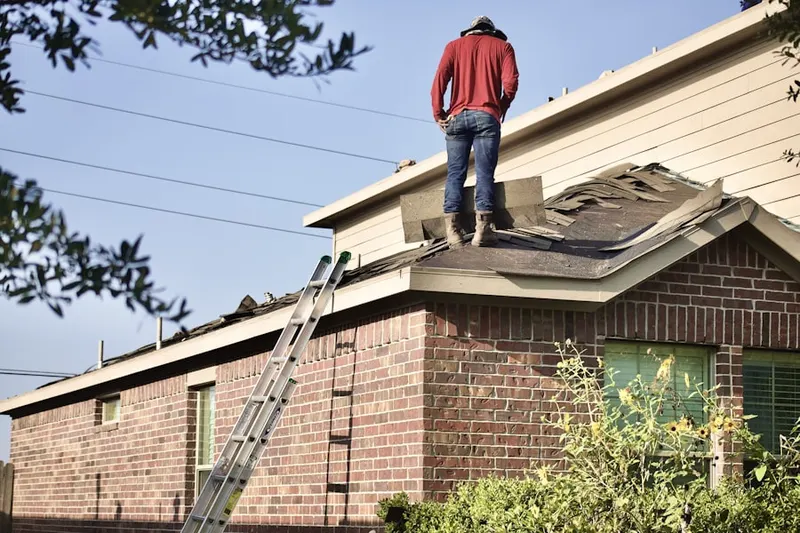 Professional roofer working on a residential roof in Purkins Corner